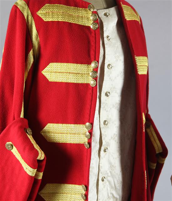 Lucia Di Lammermoor: A rail with a turquoise velvet and gold braided dress, a red and gold braided jacket, a petrol